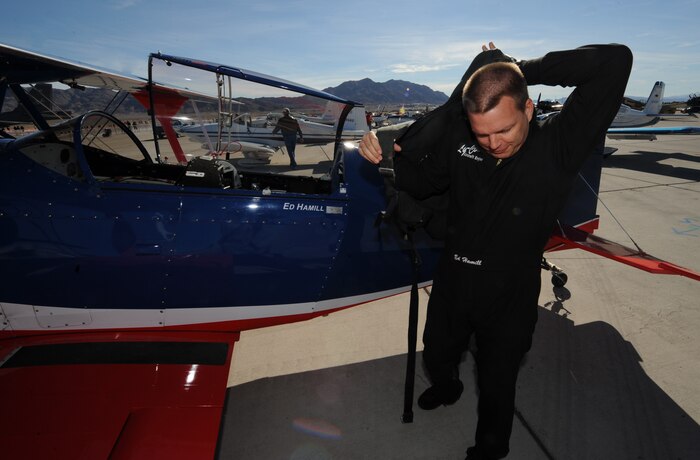 NELLIS AIR FORCE BASE, Nev.-- Lt. Col. Ed Hamill, U.S. Air Force Reservist, puts on his parachute  Nov. 14, 2010, prior to his demonstration during Aviation Nation, Nellis Air Force Base Open House and annual Las Vegas air show. "My show honors three eras of the last century of aerobatics -- the barnstormers of the '20s and '30s to the competitors of the '50s and '60s to the high energy sky dancers of today,  said Hamill. "The message throughout the show is to set goals, work hard and never give up." (U.S. Air Force photo/ Master Sgt. Kevin J. Gruenwald) (Released)	





