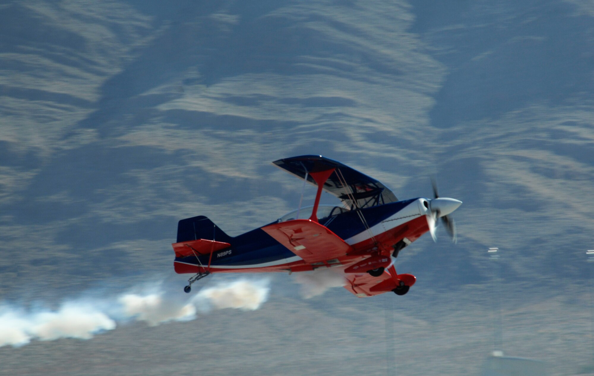 NELLIS AIR FORCE BASE, Nev.-- Lt. Col. Ed Hamill, U.S. Air Force reservist, maneuvers his biplane for the crowd of thousands on Nov. 14, 2010 during Aviation Nation, Nellis Air Force Base Open House and annual Las Vegas air show.  Ed combines the history of airshow flying with his message to  set goals, work hard and never give up.  (U.S. Air Force photo/ Master Sgt. Kevin J. Gruenwald)(Released)




