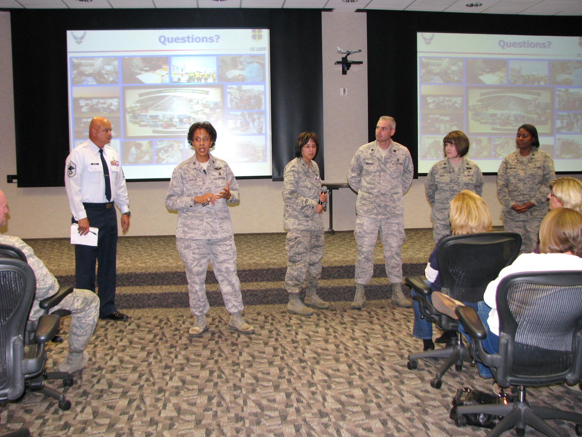 Col. Janet Taylor, 95th Medical Group commander, and her medical team talk to base residents during a town hall meeting, Nov. 9. Base leadership discussed topics including medical care, housing privatization and base schools. (Air Force photo by Diane Betzler)