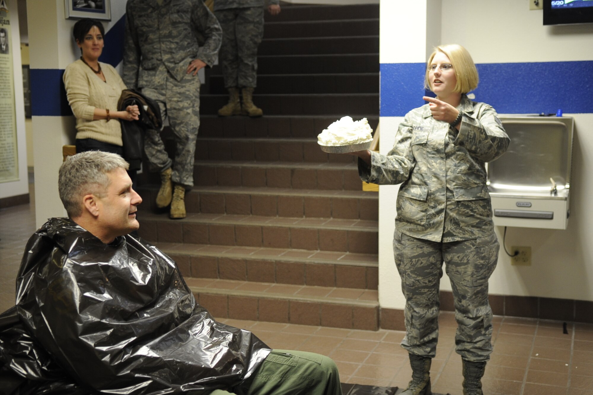 MOUNTAIN HOME AIR FORCE BASE, Idaho -- Col. Ron Buckley, 366th Fighter Wing commander, waits while Senior Airman Anastacia Rohde, 366th Comptroller Squadron financial management flight, auctions off a pie during the 2010 Pie in the Eye fundraiser here Nov. 12. More than $500 were raised during the fundraiser were donated in support of the Combined Federal Campaign. (U.S. Air Force photo by/Senior Airman Angelina Drake)