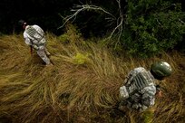 Tech. Sgt. Corey Marco, right, and Tech. Sgt. Stephen Smith secure the perimeter during convoy training Nov. 1 at Camp Bullis. Airmen attending the Combat Leadership Course gain leadership experience from classroom and field training in land navigation, convoy operations, mounted and dismounted patrols and urban warfare. (U.S. Air Force photo/Staff Sgt. Jonathan Snyder)