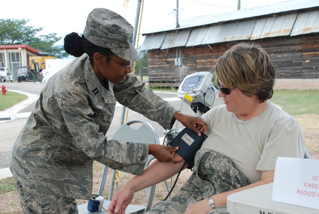 SOTO CANO AIR BASE, Honduras -- Capt. Tia Hutto, a nurse with the Joint Task Force-Bravo Medical Element, takes a blood pressure reading on Master Sgt. Danielle McClarin, the NCO in charge of preventive medicine here, as part of the JTF-B Health Fair here Nov. 18.  The fair was held in conjuction with the 35th anniversary of the American Cancer Society's Great American Smoke-Out campaign and featured several stations, including heart health, diabetes awareness, tobacco use cessation, sexually transmitted disease prevention and women's health.  (U.S. Air Force photo/Capt. John T. Stamm)