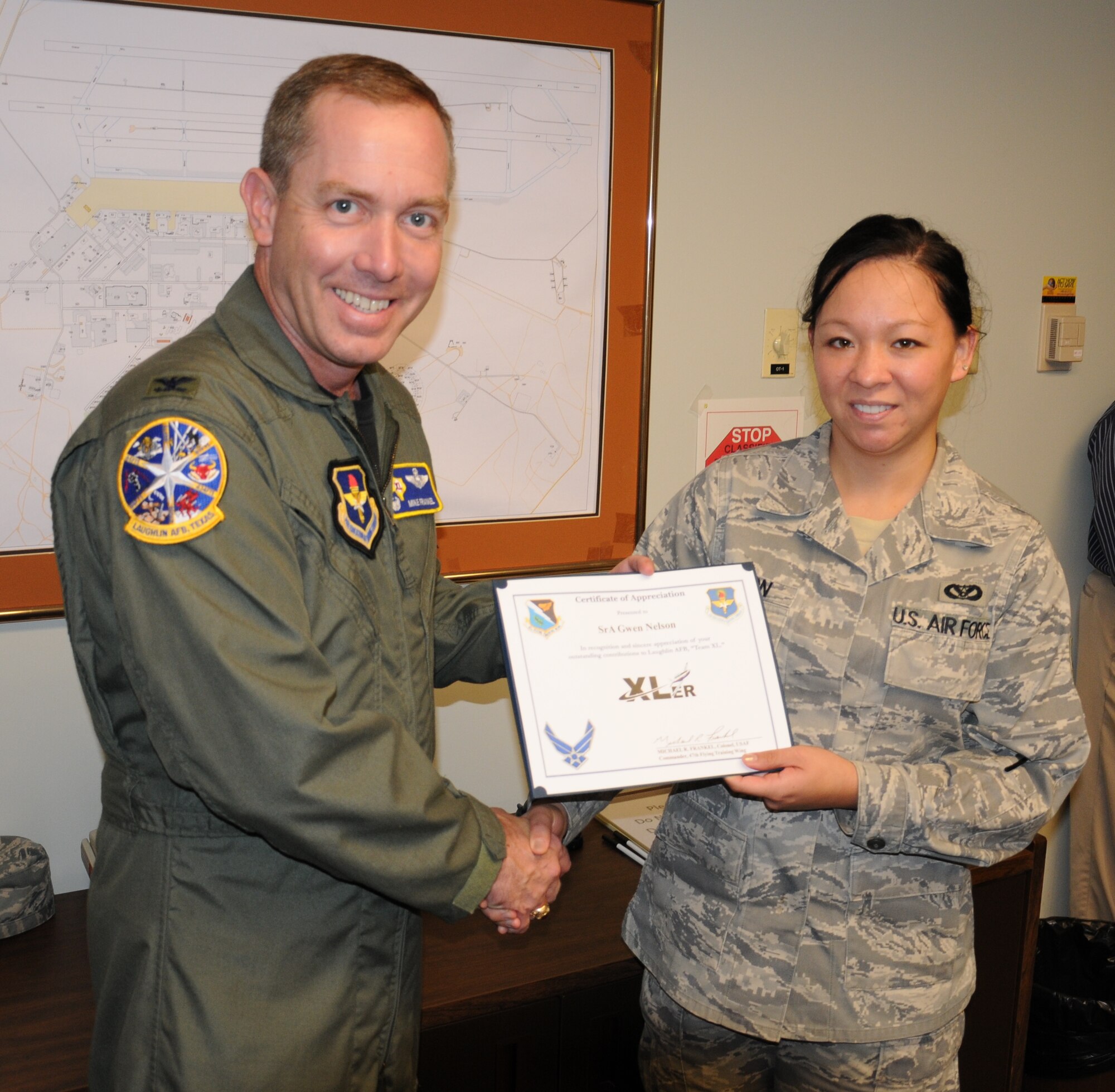 LAUGHLIN AIR FORCE BASE, Texas – Senior Airman Gwen Nelson, 47th Civil Engineering Squadron, is presented the XLer of the Week award by Col. Michael Frankel, 47th Flying Training Wing commander, here Nov. 10. The XLer is a weekly award chosen by 47th FTW leadership and given to individuals who consistently make outstanding contributions to Laughlin and their unit. (U.S. Air Force photo by Airman 1st Class Blake Mize)
