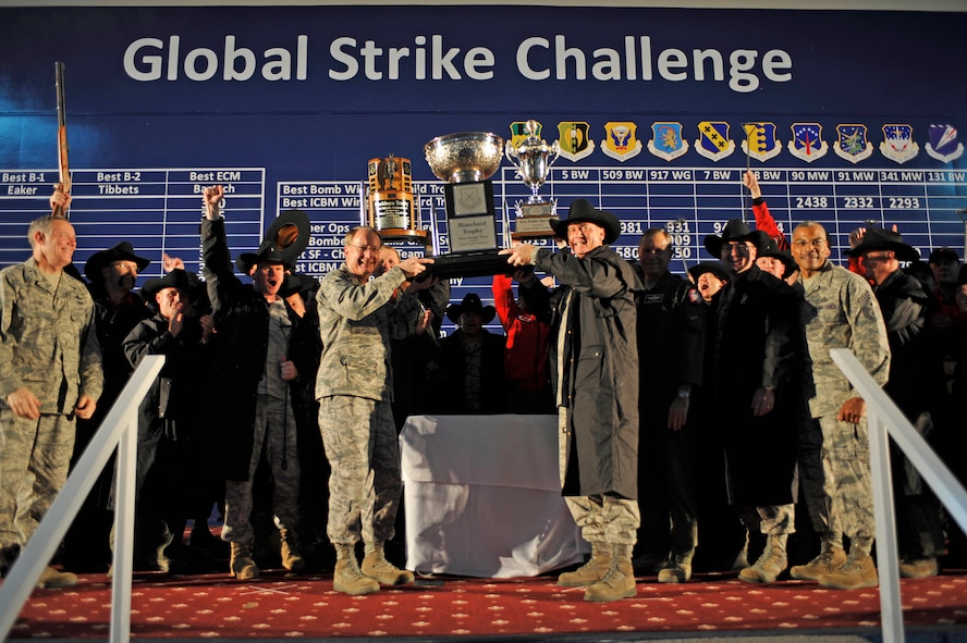 Lieutenant Gen. Frank G. Klotz, commander, Air Force Global Strike Command, presents the Blanchard Trophy to Col. Greg Tims, 90th Missile Wing commander, and the "Warren Wranglers" at the award presentation for the Global Strike Challenge held at Barksdale Air Force Base, La., Nov. 17. The 90th MW team also won the Blackburn Trophy (best ICBM maintenance), best ICBM Operations Trophy and the best ICBM Electro-Mechanical Team Trophy. During score posting events, many teams displayed team spirit and mission heritage by donning competitive gear representative of their unit traditions as well as incorporating team masxots into activities. (U.S. Air Force photo by Senior Airman Chad Warren)