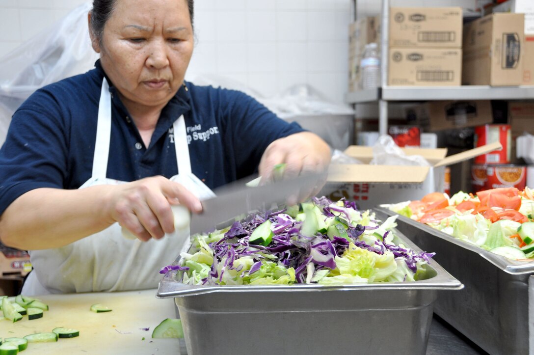 Nam Dodson prepares salads in the Hap Arnold Club kitchen Oct. 16, 2010.  During unit training assembly weekends, the club staff prepares food for troop feeding and conference center events.  (U.S. Air Force photo/Linda Welz)