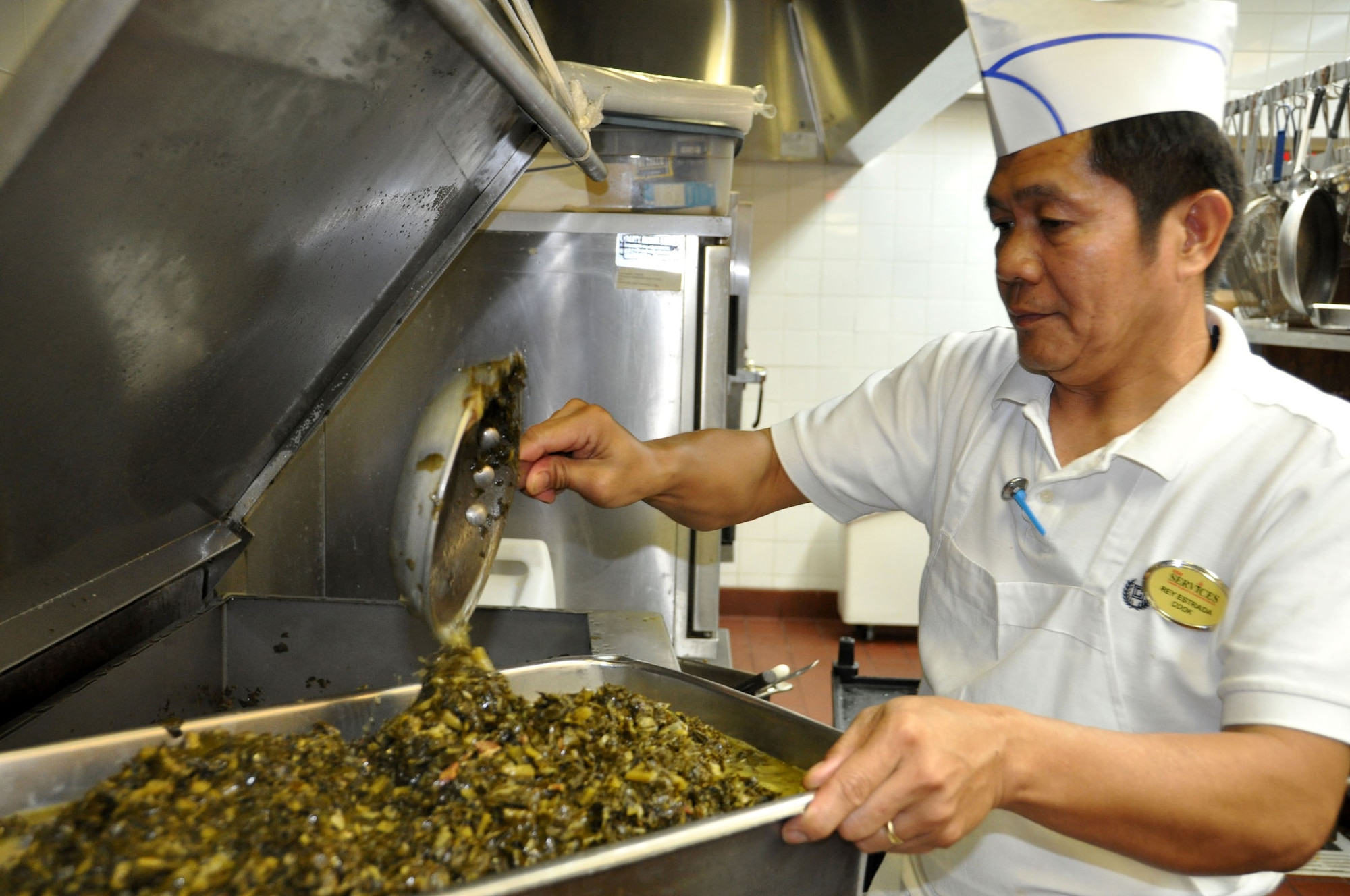 Rey Estrada prepares a meal in the Hap Arnold Club kitchen Oct. 16, 2010.  During unit training assembly weekends, the club staff prepares food for troop feeding and conference center events.  (U.S. Air Force photo/Linda Welz)