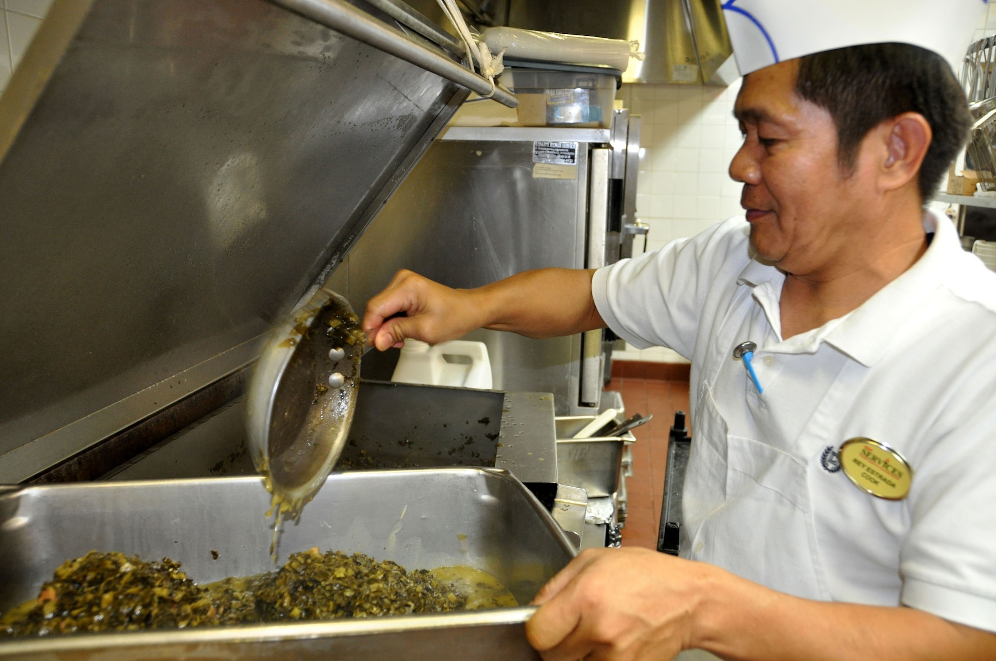 Rey Estrada prepares a meal in the Hap Arnold Club kitchen Oct. 16, 2010.  During unit training assembly weekends, the club staff prepares food for troop feeding and conference center events.  (U.S. Air Force photo/Linda Welz)