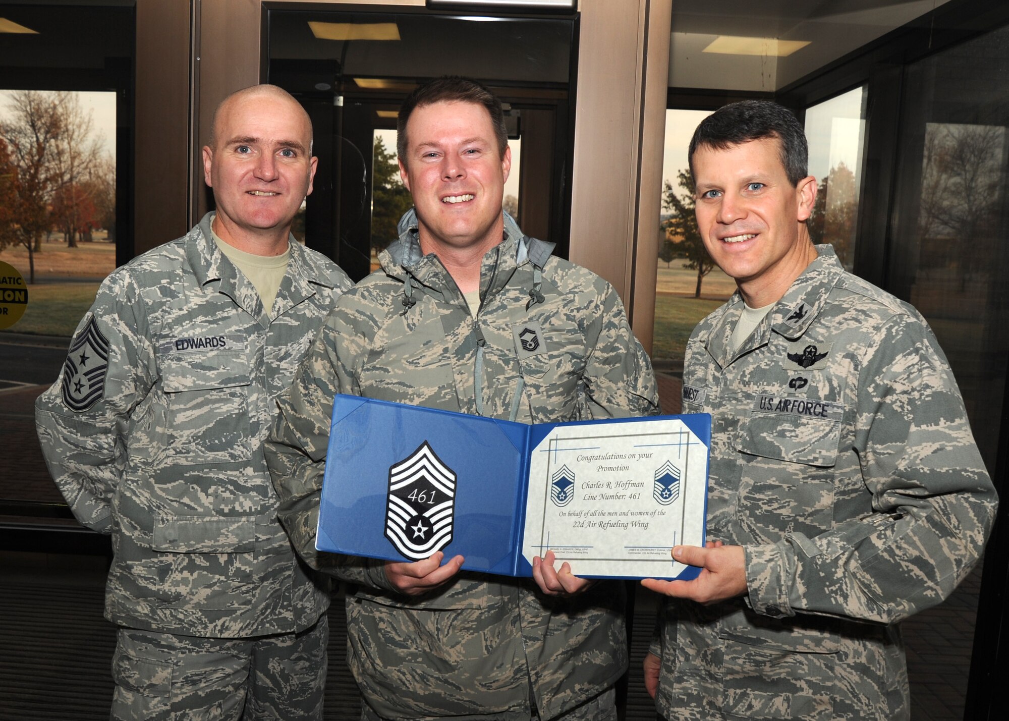 Chief Master Sgt. Michael Edwards, 22nd Air Refueling Wing command chief, left, and Col. Jamie Crowhurst, 22nd Air Refueling Wing commander, right, congratulate Senior Master Sgt. Charles Hoffman, 22nd Operations Support Squadron superintendant, on his selection to chief master sergeant, Nov. 18, 2010, McConnell Air Force Base, Kan. Three McConnell Airmen were promoted to the rank of chief master sergeant.  (U.S. Air Force photo/Staff Sgt. Dallas Edwards)