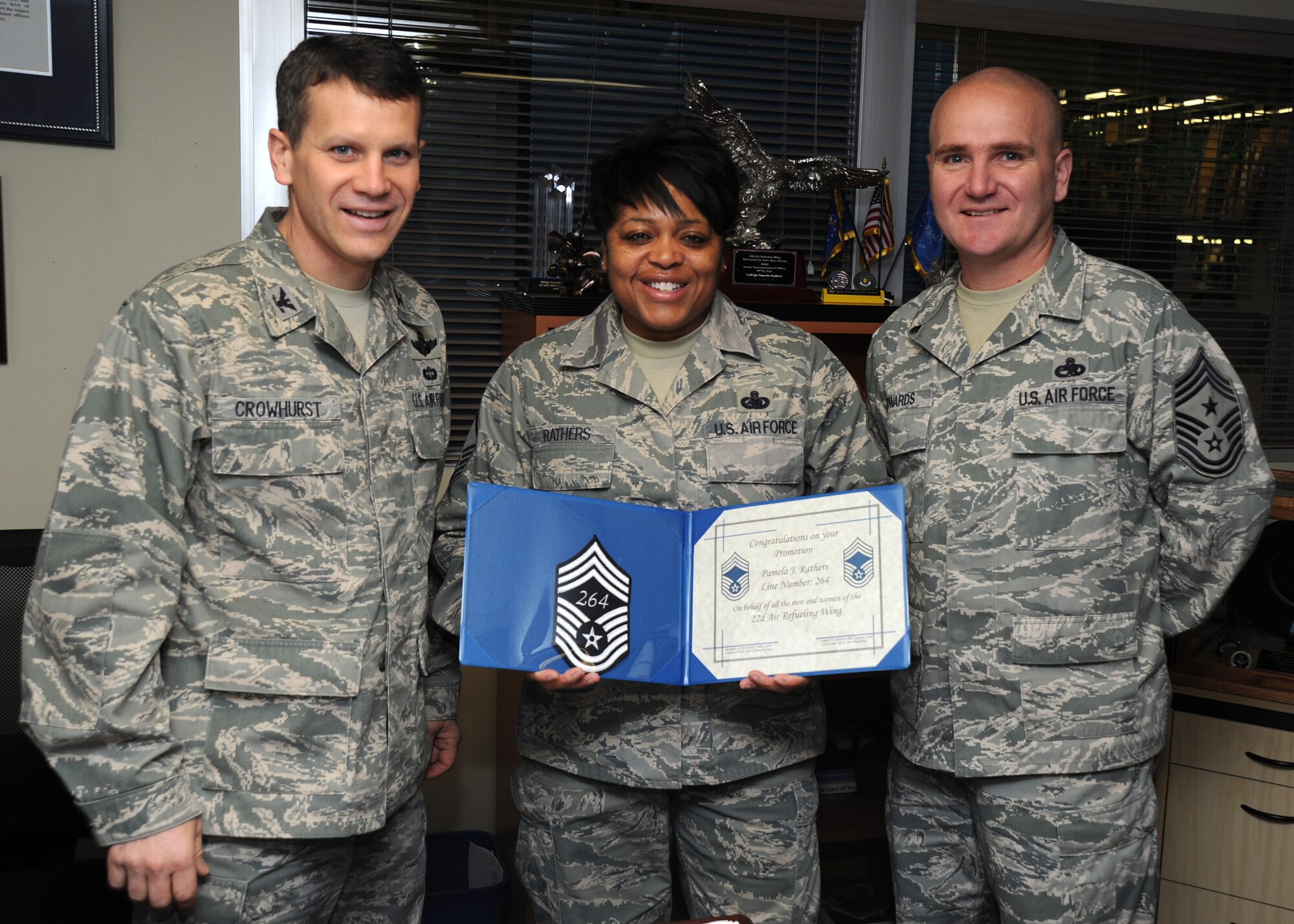 Col. Jamie Crowhurst, 22nd Air Refueling Wing commander, left, and Chief Master Sgt. Michael Edwards, 22nd Air Refueling Wing command chief, right, congratulate Senior Master Sgt. Pamela Rathers, 22nd Logistics Readiness Squadron material management flight superintendent, on her selection to chief master sergeant, Nov. 18, 2010, McConnell Air Force Base, Kan.  The Air Force promoted 504 senior master sergeants to the rank of chief master sergeant.  (U.S. Air Force photo/Staff Sgt. Dallas Edwards)