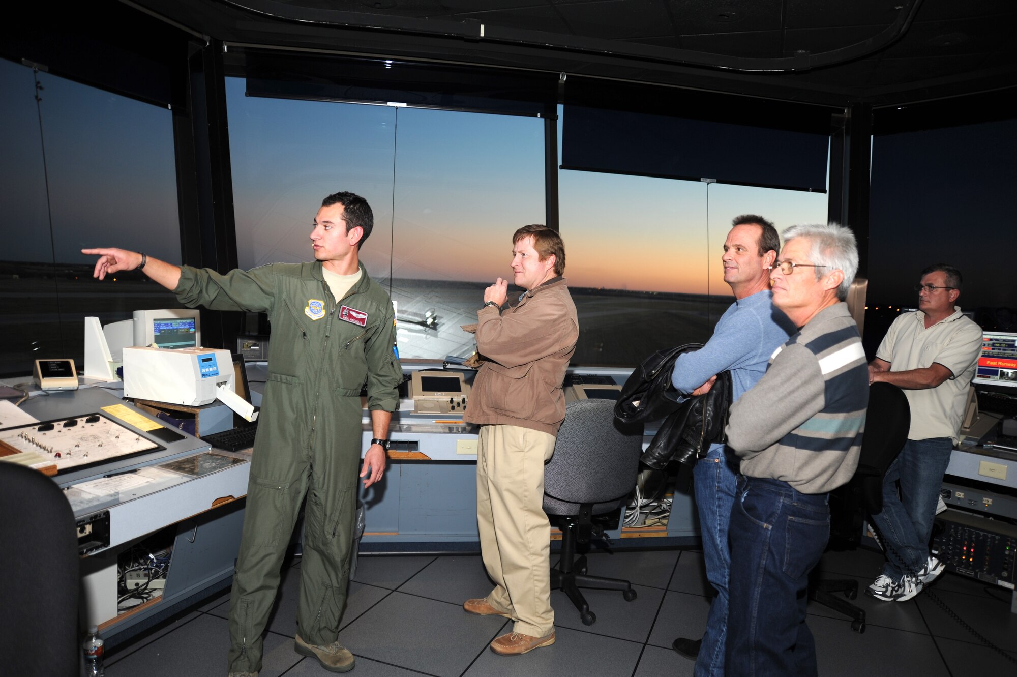 First Lt. Paul Viscuglia, 384th Air Refueling Squadron executive officer and pilot, talks with local landowners about in-flight bird strikes in the air traffic control tower, Nov. 16, 2010, McConnell Air Force Base, Kan.  Several landowners were invited to the base.  The BASH program is a humane way to control the McConnell area bird population.  (U.S. Air Force photo/Staff Sgt. Dallas Edwards)