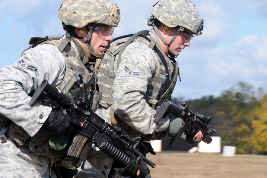 Airman 1st Class Steven Whaley, 91st Security Forces Squadron Tactical Response Force marksman and Airman 1st Class Ryan Fontaine, Convoy Response Force Leader from Minot Air Force Base, N.D., run back to the starting point of the M203 grenade launcher firing competition during Global Strike Challenge at Barksdale AFB, La., Nov. 16. The competition was designed to enhance readiness, teamwork, esprit de corps, mission pride, and a competitive spirit. (U.S. Air Force photo/Senior Airman Brittany Y. Bateman)(RELEASED)