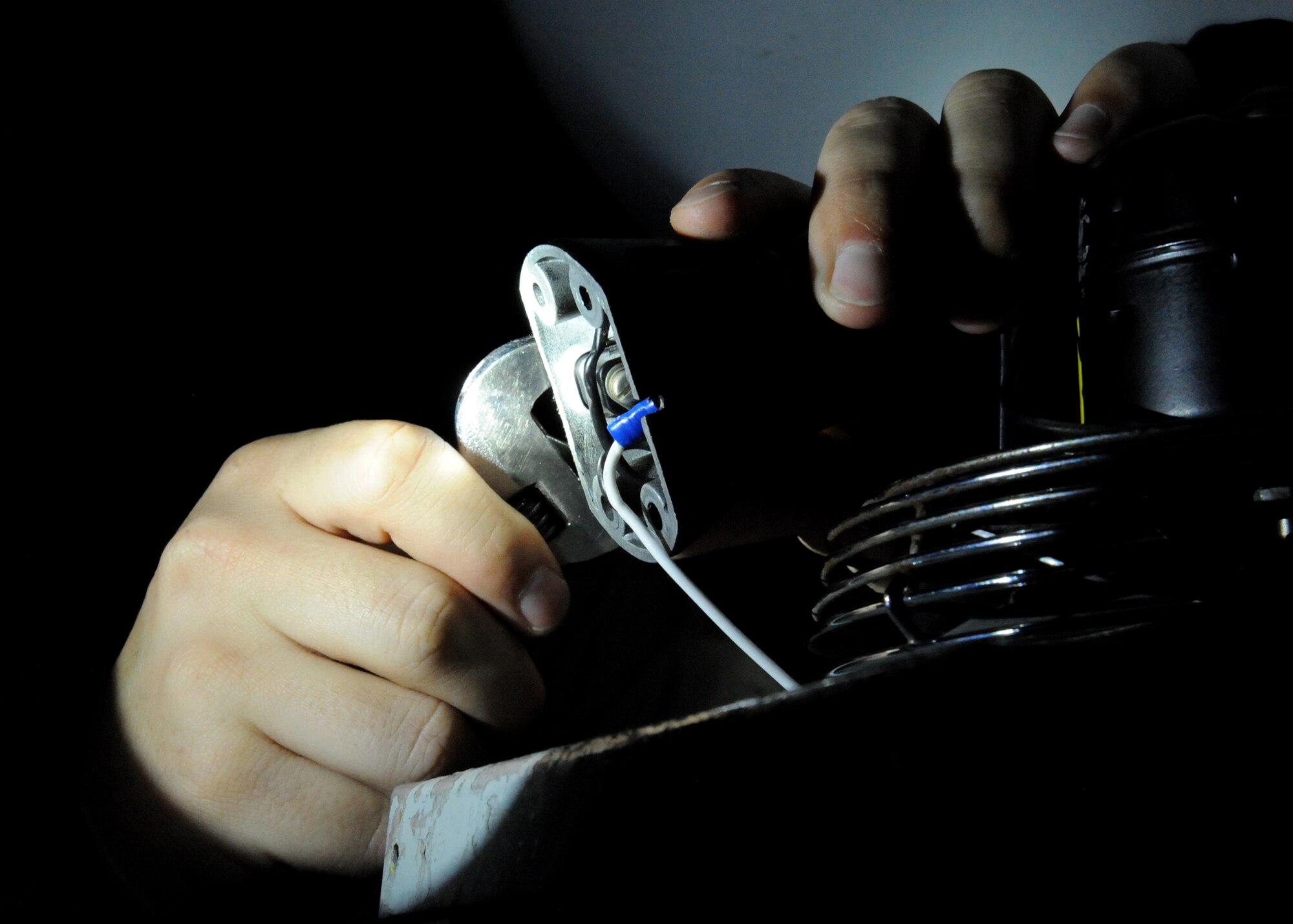 Senior Airman Kyle Burks, 22nd Maintenance Squadron electro-environmental systems journeyman, unscrews a switch on the base of a cooling fan in the cockpit of a KC-135 Stratotanker, Nov. 16, 2010, McConnell Air Force Base, Kan. To ensure the crew is safe while working on certain parts of the aircraft, maintainers keep the plane powered down. (U.S. Air Force photo/Airman 1st Class Katrina M. Brisbin)