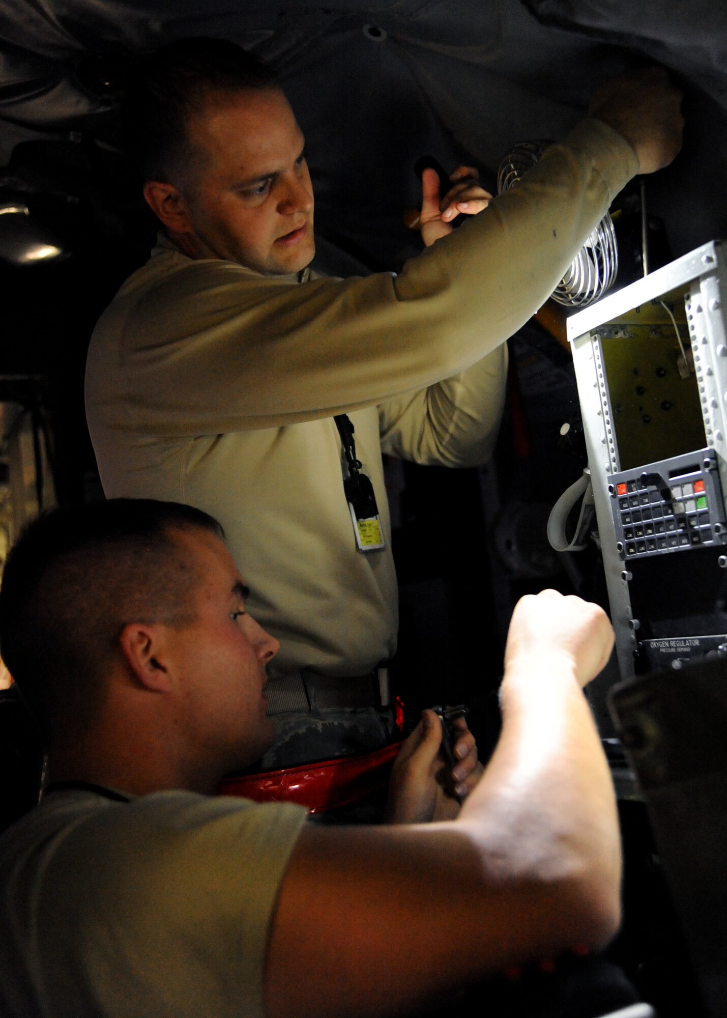 Senior Airman Kyle Burks, 22nd Maintenance Squadron electro-environmental systems journeyman, and Staff Sgt. Joshua Lacey, 22nd MXS electro-environmental systems craftsman, replace a cooling fan in the cockpit of a KC-135 Stratotanker for an isochronal inspection, Nov. 16, 2010, McConnell Air Force Base, Kan. Cooling fans along with heated vents are used to regulate temperature to make working environments comfortable for aircrew. (U.S. Air Force photo/Airman 1st Class Katrina M. Brisbin)