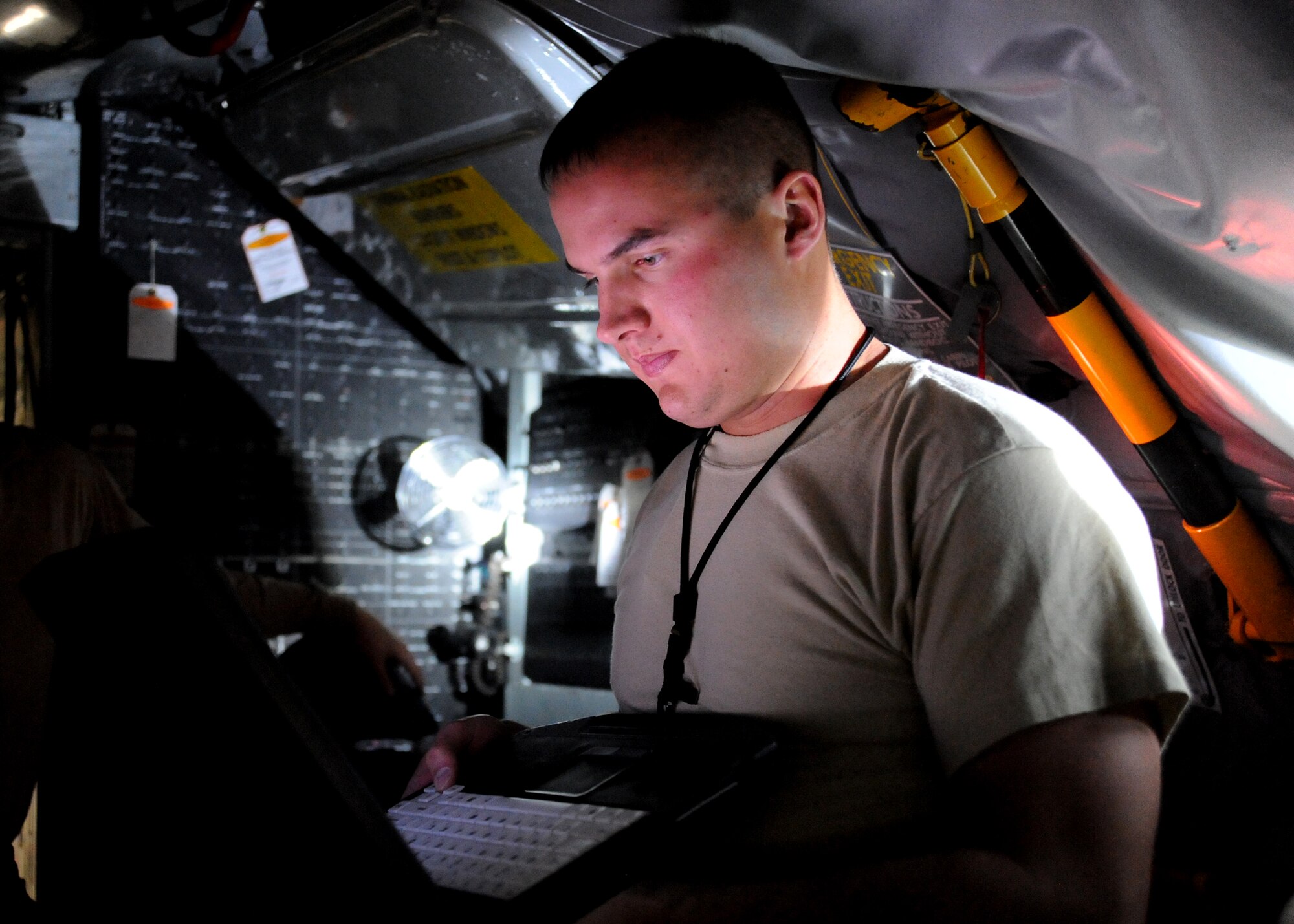 While in the cockpit of a KC-135 Stratotanker, Staff Sgt. Joshua Lacey, 22nd Maintenance Squadron electro-environmental systems craftsman, scans technical data on a laptop computer, Nov. 16, 2010, McConnell Air Force Base, Kan. Laptop computers contain technical data needed to do specific jobs for isochronal inspections. (U.S. Air Force photo/Airman 1st Class Katrina M. Brisbin)
