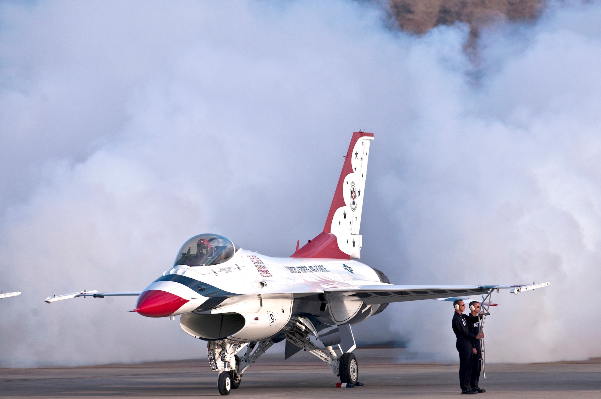 Maj. Rick Goodman, lead solo with the Air Force Air Demonstration Squadron, the Thunderbirds, releases smoke and as he prepares to exit his F-16 Fighting Falcon at the 2010 air show at Nellis Air Force Base, Nev., Nov. 14, 2010. The open house is the final air show of the year for the squadron. (U.S. Air Force photo/Tech. Sgt. Michael R. Holzworth)