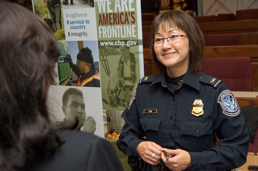 HANSCOM AIR FORCE BASE, Mass. - Laurie Thai, a U.S. Customs and Border Protection Officer from the Department of Homeland Security, speaks to Lynda DeMeo during the job fair at the Hanscom Conference Center on Nov. 12. Representatives from more than 40 public and private agencies attended the fair to meet potential employees and provide information on a variety of job openings. (U.S. Air Force photo by Mark Wyatt)