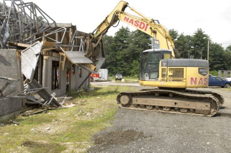 HANSCOM AIR FORCE BASE, Mass. – A bulldozer tears down old construction in order to make way for the new at Hanscom. As a result of privatized housing, military members, DoD civilians, contractors, retirees and their families now have options when deciding to move on base. (Courtesy photo)