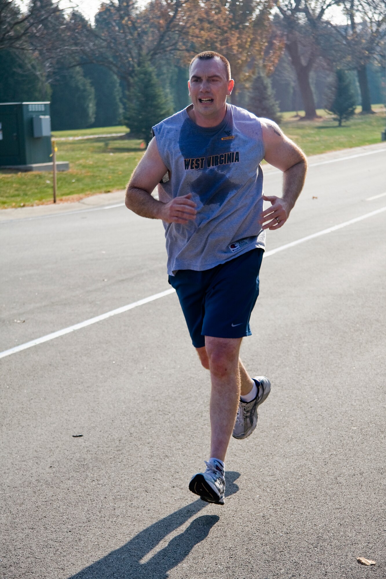 GRISSOM AIR RESERVE BASE, Ind. -- Matt Coakley races to the finish line during a 5-kilometer "Turkey Trot" run held at the fitness center here Nov. 17. Participants guessed how long it would take them to finish the race prior to starting the run. The top three runners whose guesses were closest to their actual run time received a turkey. While Coakley crossed the finish line third with a time of 23 minutes, 27 seconds, his guess was not good enough to bring home a bird. Raymond McNitt, Rich Percival and Juan Hernandez came in closest to their predicted times. (U. S. Air Force photo/Tech. Sgt. Mark R. W. Orders-Woempner)