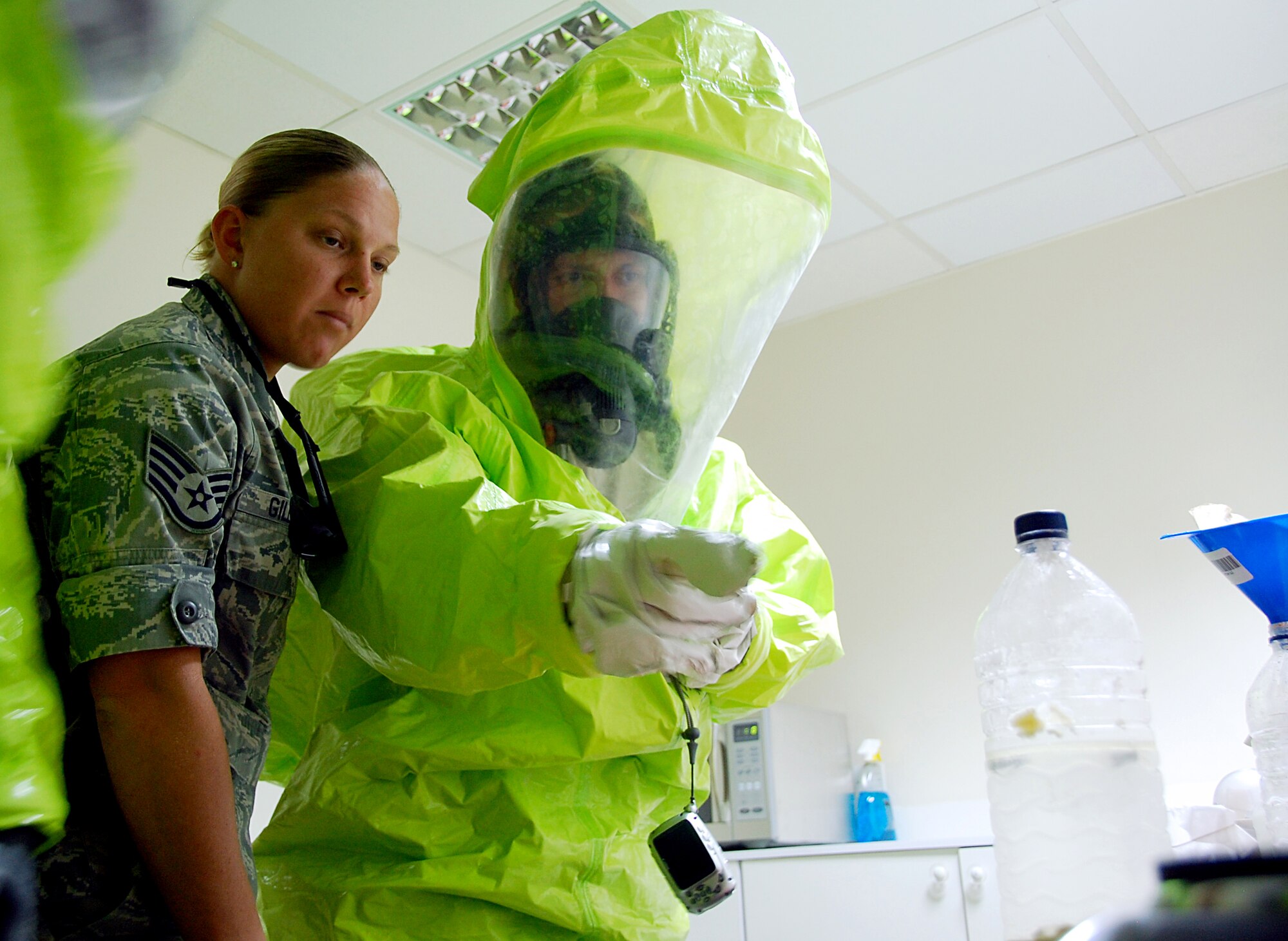 SOUTHWEST ASIA ? Staff Sgt. Natalie Gillett guides a firefighter through the proper response procedures during a hazardous-material training scenario here Nov. 12. Sergeant Gillett is a part of the 386th Expeditionary Civil Engineer Squadron Emergency Management Flight and is deployed from the 182nd Airlift Wing, Illinois Air National Guard. (U.S. Air Force photo by Staff Sgt. Stefanie Torres)