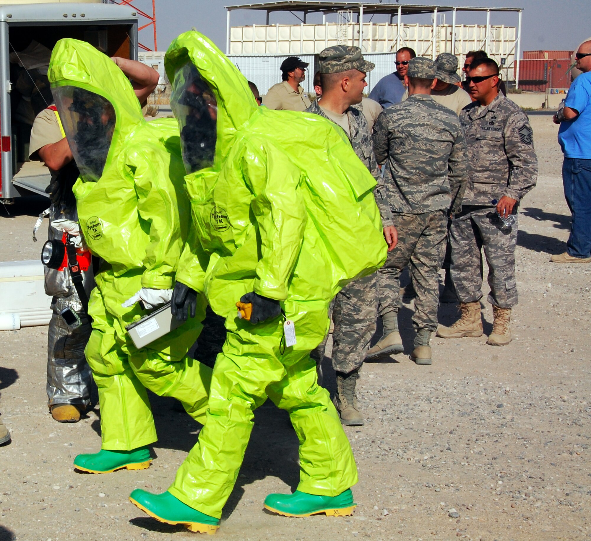 SOUTHWEST ASIA ? Firefighters from the 386th Expeditionary Civil Engineer Squadron enter a simulated contaminated site during a training scenario held at an undisclosed air base here Nov. 12. The scenario, sponsored by the 386th ECES Emergency Management Flight, was part of a Department of Defense certification program to train firefighters as hazardous-material response technicians. (U.S. Air Force photo by Staff Sgt. Stefanie Torres)