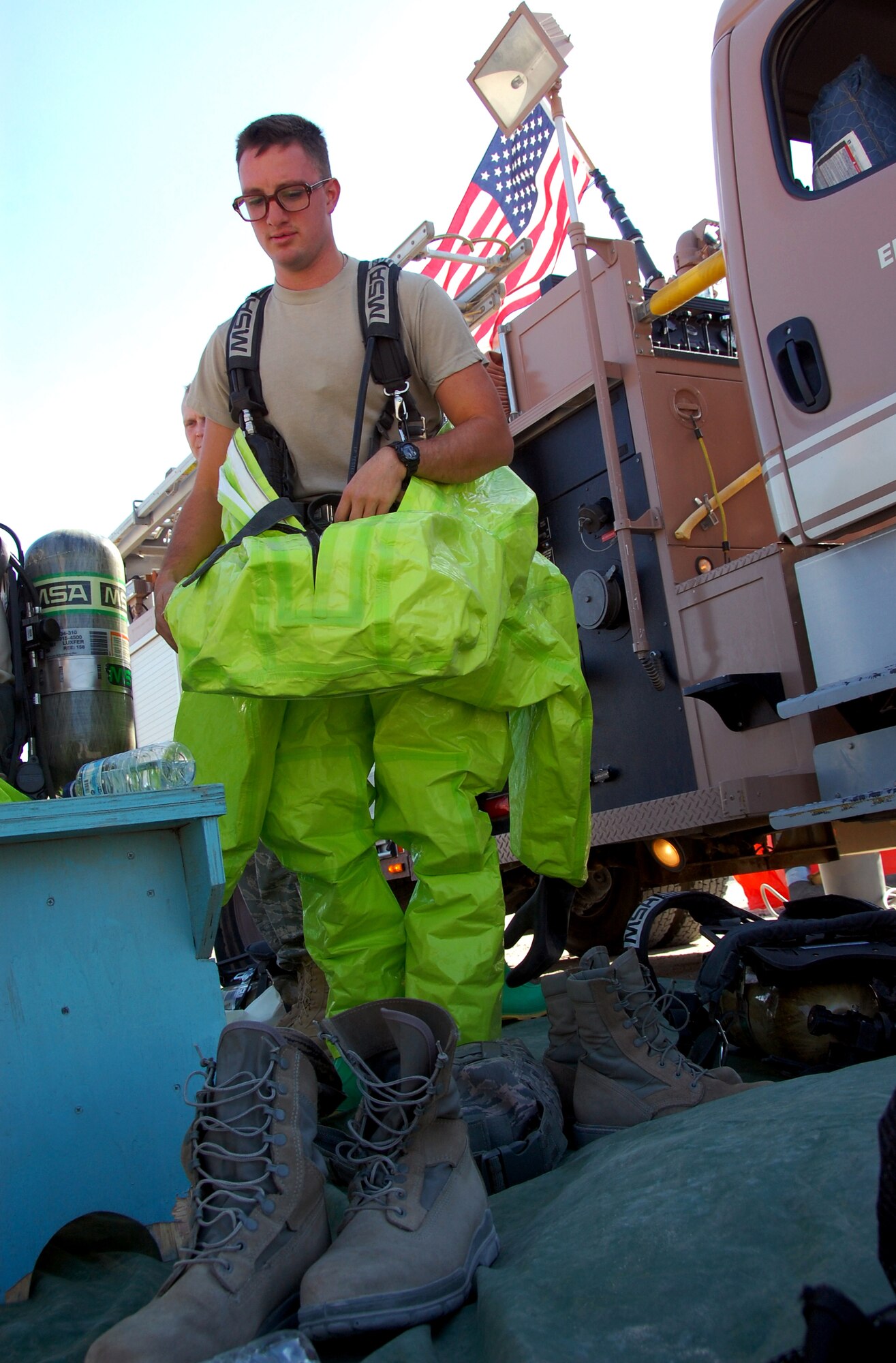 SOUTHWEST ASIA ? Senior Airman Travis Meehan, a firefighter from the 386th Expeditionary Civil Engineer Squadron, dons a protective chemical suit before participating in a training scenario at an undisclosed air base here Nov. 12. The class-A suit provides the highest level of protection against environmental pathogens and contaminants. The exercise was part of a Department of Defense certification program to train firefighters as hazardous-material response technicians. Airman Meehan is deployed from the 106th Rescue Wing, New York Air National Guard. (U.S. Air Force photo by Staff Sgt. Stefanie Torres)