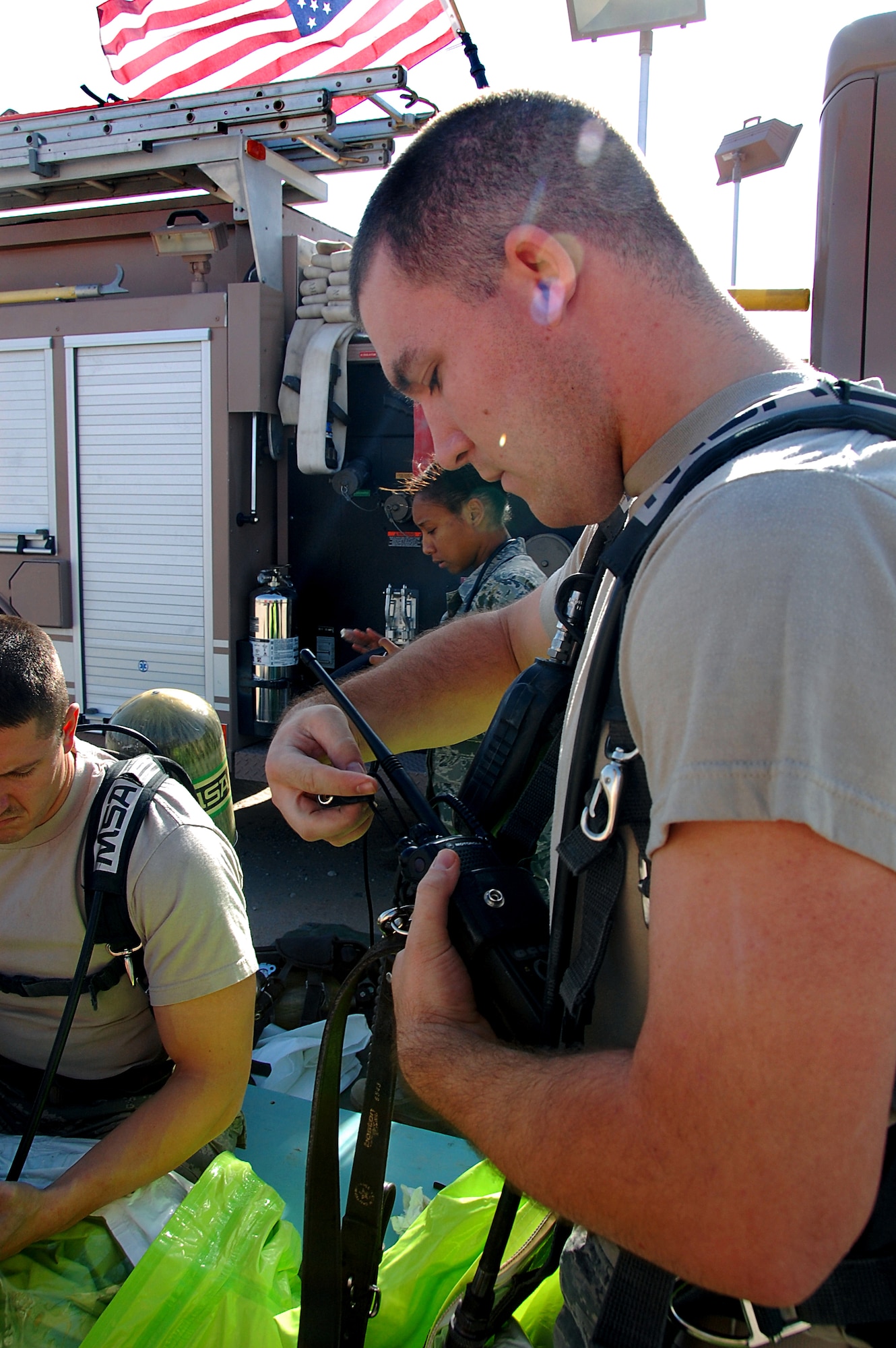 SOUTHWEST ASIA?Senior Airman Corbin Hamernik, a firefighter from the 386th Expeditionary Civil Engineer Squadron, checks his radio equipment Nov. 12 before participating in a training scenario here involving simulated hazardous chemicals. The exercise was part of a Department of Defense certification program to train firefighters as hazardous-material response technicians. Airman Hamernik is deployed from the 155th Air Refueling Wing in Lincoln, Neb. (U.S. Air Force photo by Staff Sgt. Stefanie Torres)