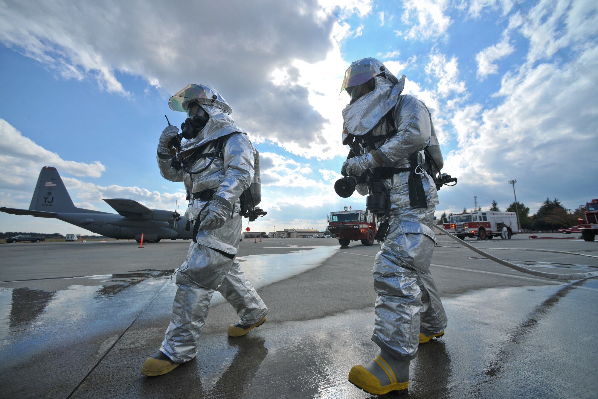 YOKOTA AIR BASE, Japan -- Firefighters from the 374th Civil Engineer Squadron respond to a simulated C-130 egress scenario here Nov. 18 during the wing's Operational Readiness Exercise. (U.S. Air Force photo/Osakabe Yasuo) 