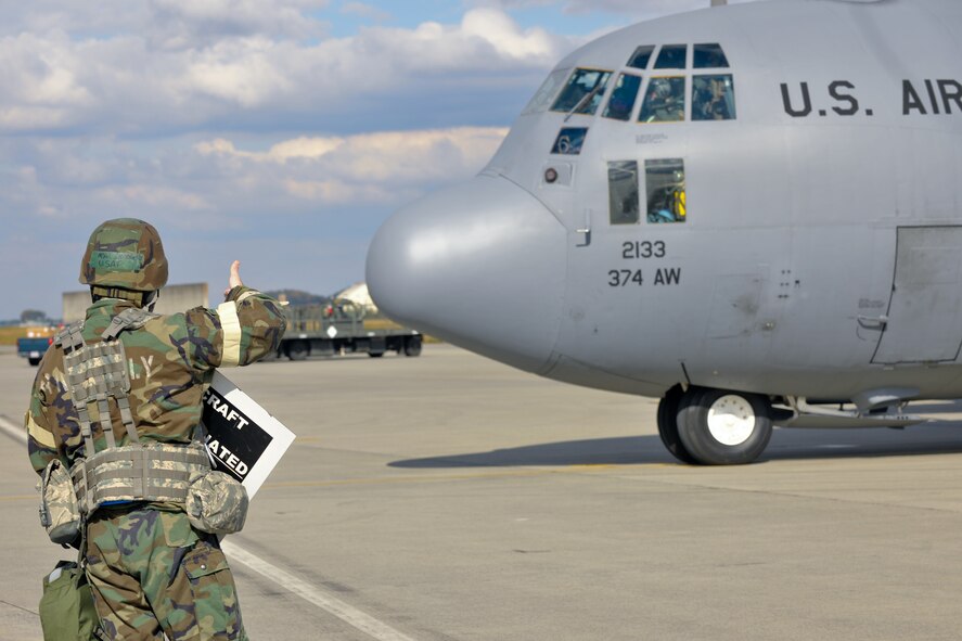 YOKOTA AIR BASE, Japan -- Master Sgt. Scott Owejan, 374th Aircraft Maintenance Squadron, prepares a simulated contaminated aircraft sign here Nov. 18 during the wing's Operational Readiness Exercise. (U.S. Air Force photo/Osakabe Yasuo) 