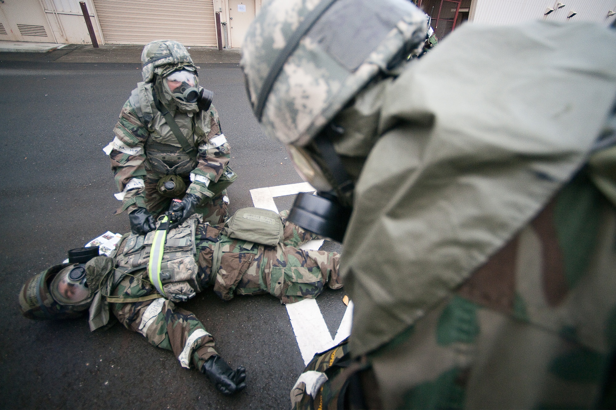 YOKOTA AIR BASE, Japan -- Tech. Sgt Ann Schenck, 374th Security Forces Squadron, practices using  a simulated nerve agent antidote injector on a victim here Nov. 17 during the wing's Operational Readiness Exercise. (U.S. Air Force photo/Osakabe Yasuo)