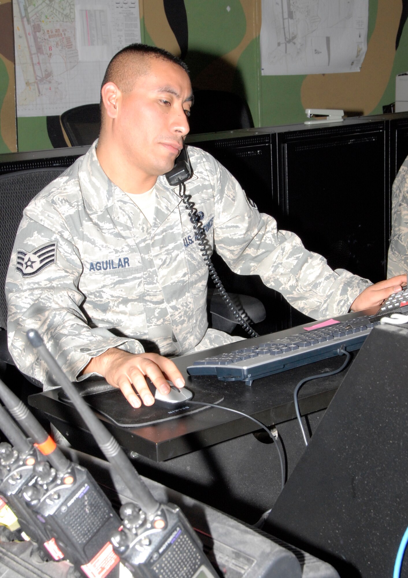 KUNSAN AIR BASE, Republic of Korea -- Staff Sgt. Omar Aguilar, 8th Communications Squadron comm focal point technician, takes a trouble call from a customer Nov. 17. The comm focal point, or help desk, is responsible for receiving trouble calls and generating trouble tickets for telephone and network issues across the wing. (U.S. Air Force photo/Staff Sgt. Amanda Savannah