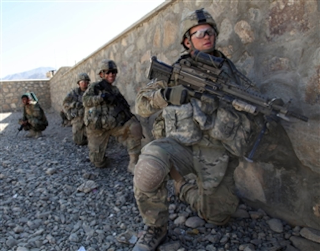 U.S. Army soldiers with Charlie Troop, 3rd Squadron, 89th Cavalry, 4th Infantry Brigade Combat Team, 10th Mountain Division wait for the order to move against enemy positions in Charkh, Logar province, Afghanistan, on Nov. 13, 2010.  