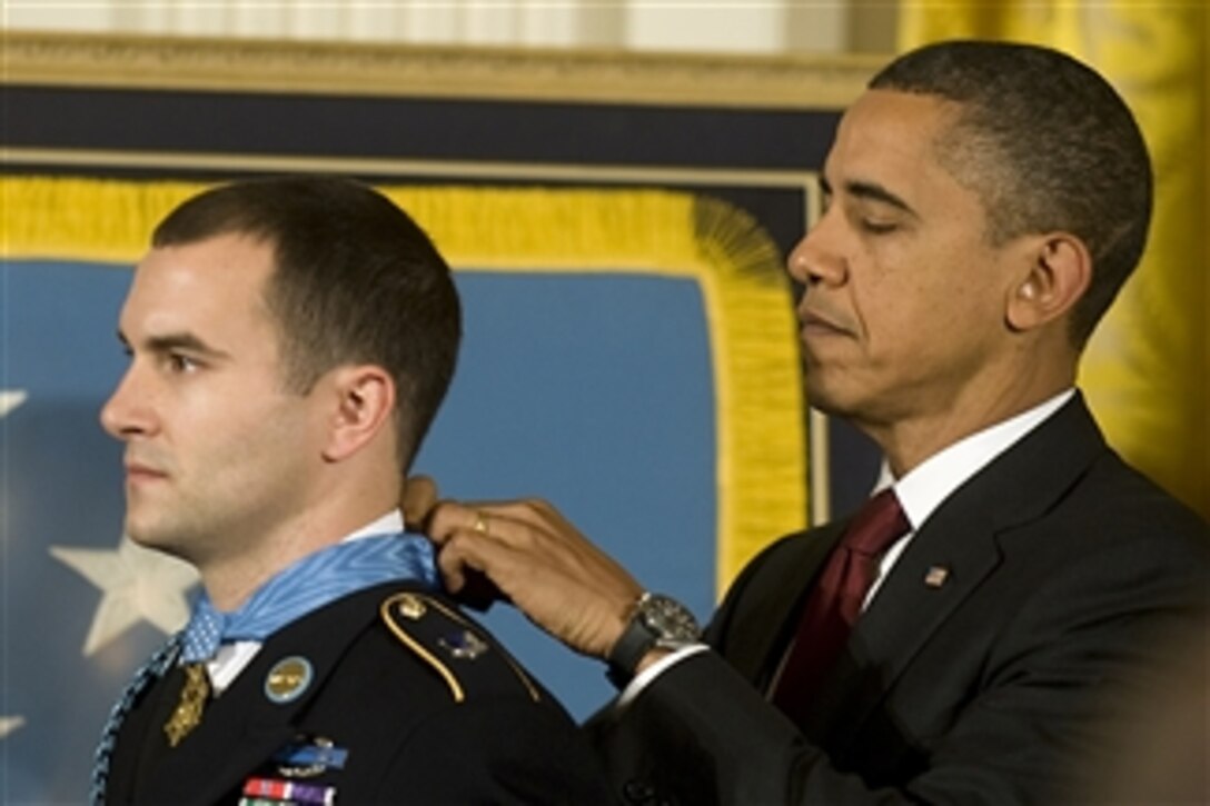 President Barack Obama presents the Medal of Honor to Staff Sgt. Salvatore Giunta, who rescued two members of his squad in October 2007 while fighting in the war in Afghanistan, in the White House in Washington, D.C., on Nov. 16, 2010.  
