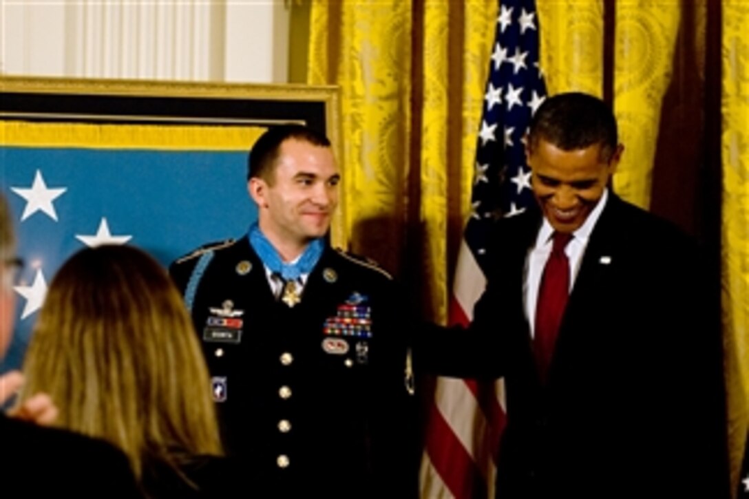President Barack Obama congratulates U.S. Army Staff Sgt. Salvatore Giunta after presenting him the Medal of Honor in the White House in Washington, D.C., on Nov. 16, 2010.  