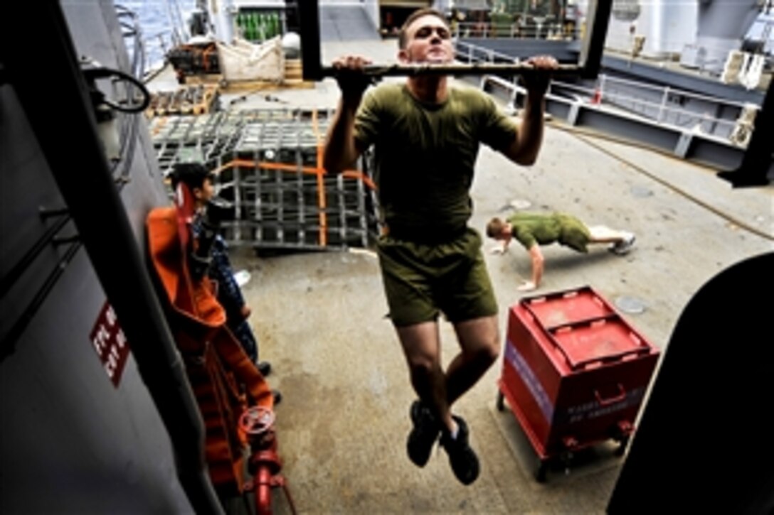 U.S. Marine Corps Lance Cpl. Brendon Wald does pull-ups aboard the amphibious dock landing ship USS Tortuga in the Pacific Ocean, Nov. 16, 2010. Wald is assigned to the 31st Marine Expeditionary Unit.