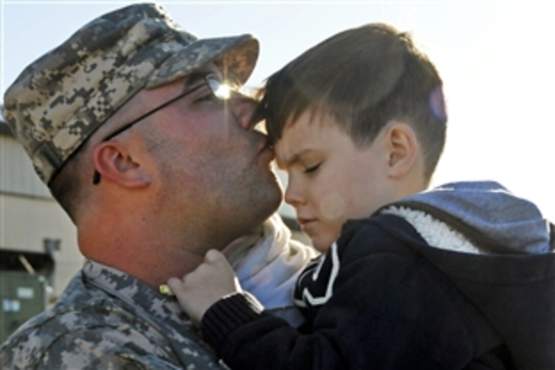 U.S. Army Spc. Keith Torres gives his son, Brendon, 4, a kiss before departing from Knox Army Heliport on Fort Rucker, Ala., Nov. 10, 2010, to the Middle East. Torres is an air traffic control equipment repair specialist assigned to the 597th Maintenance Company.
