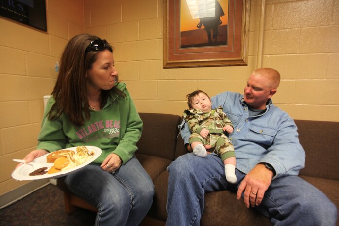 Chief Petty Officer Terry Sitton, safety officer, 2nd Medical Battalion, Combat Logistics Regiment 25, 2nd Marine Logistics Group, enjoys time with his wife and nephew, Nov. 19, 2010, at a battalion family day held in a preemptive observance of Thanksgiving Day.  Many of the battalion’s personnel are slated to support Operation Enduring Freedom in Afghanistan during the near future. (Official Marine Corps Photo by Cpl. Bobbie A. Curtis)