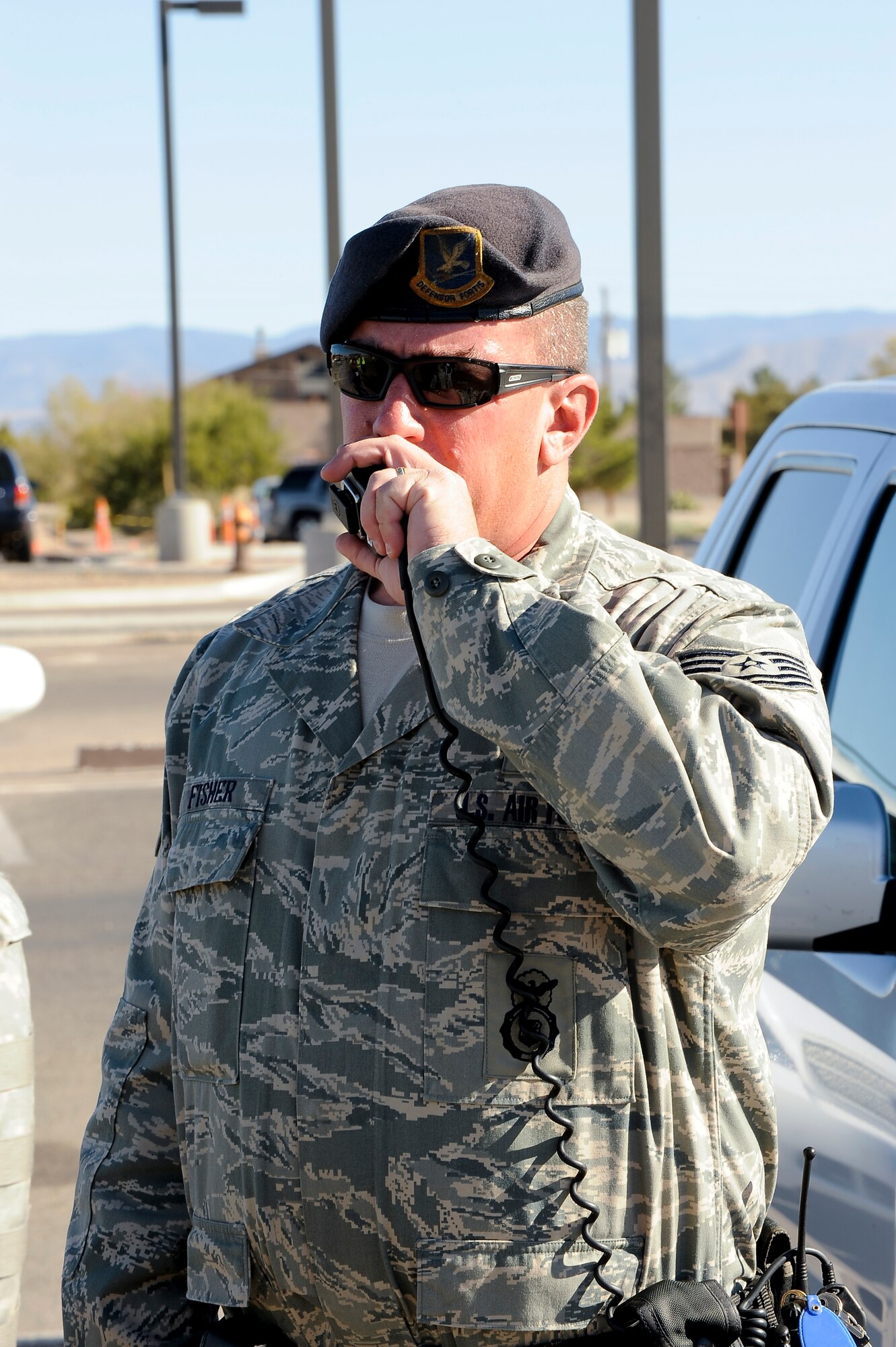 HOLLOMAN AIR FORCE BASE, N.M. -- Tech. Sgt. Matthew Fisher, 49th Security Forces Squadron, radios in to the Base Defense Operations Center during an anti-terrorism exercise Nov. 18, 2010. During the scenario, role-playing members from a criminal group threatened the base and 49th SFS Airmen were called-in to take control of the situation and apprehended the role-playing individuals. The scenario was part of a base-wide exercise which tested Team Holloman's ability to respond to an emergency situation and to effectively execute changes to Force Protection Condition in response. The exercise was also held in preparation for the upcoming Operational Readiness Inspection, slated for April 2011. (U.S. Air Force photo by Tech. Sgt. Alan Port/Released)