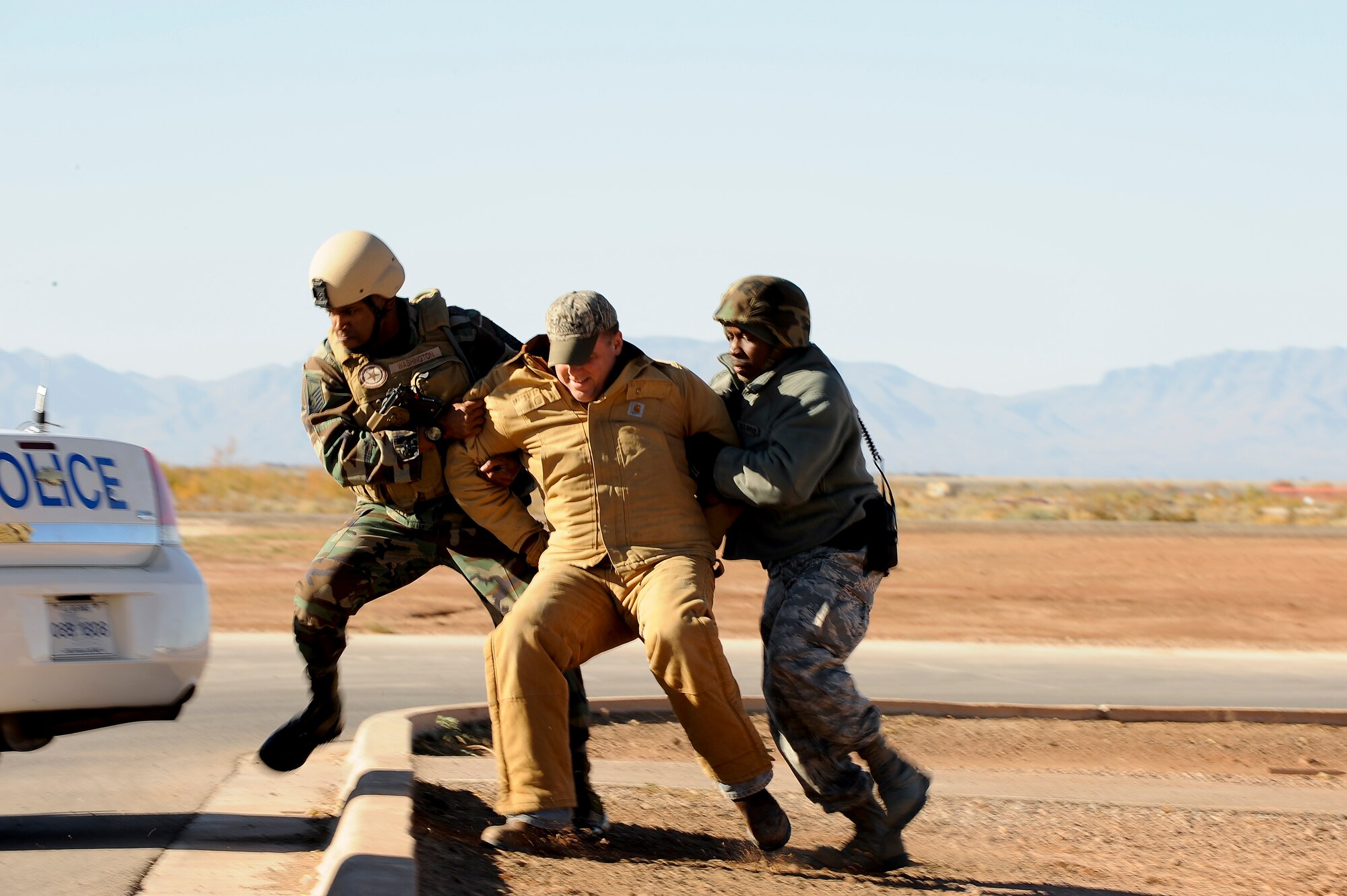 HOLLOMAN AIR FORCE BASE, N.M. -- Members of the 49th Security Forces Squadron apprehend one of two role-playing terrorists during an exercise Nov. 18, 2010. During the scenario, role-playing members of a criminal group threatened the base and 49th SFS Airmen were called-in to take control of the situation. The anti-terrorism exercise tested Team Holloman's ability to respond to an emergency situation and to effectively execute changes to Force Protection Condition in response. (U.S. Air Force photo by Tech. Sgt. Alan Port/Released)