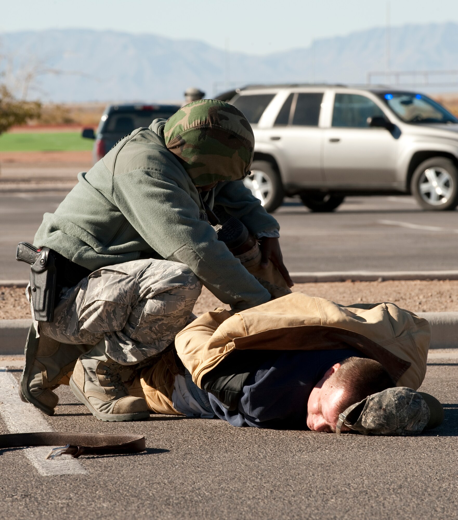 HOLLOMAN AIR FORCE BASE, N.M. -- A member of the 49th Security Forces Squadron searches a role-playing terrorist during an anti-terrorism exercise Nov. 18, 2010. The exercise scenario involved a potential threat against the base from simulated terrorists who had access to the base and to explosives. Members of the base were tested in their ability to respond to the emergency situation and to effectively execute changes to Force Protection Condition in response. The exercise was also held in preparation for the upcoming Operational Readiness Inspection, slated for April 2011. (U.S. Air Force photo by Senior Airman Sondra Escutia/Released)