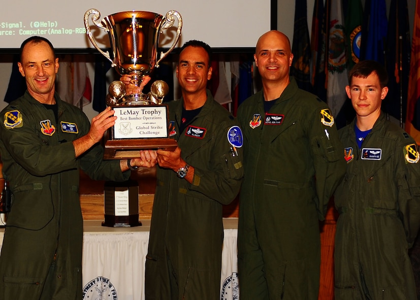 DYESS AIR FORCE BASE, Texas—Col. David Been, 7th Bomb Wing commander, presents the LeMay Trophy to Lt. Col. Patrick Klinger (left), Lt. Col. Michael Starr (middle), and Capt. Brad Weber (right), Nov. 19 here. Global Strike Challenge is the world’s premier bomber, intercontinental ballistic missile operations and security forces competition with units from Air Force Global Strike Command, Air Combat Command, Air Force Reserve Command and the Air National Guard. Team Dyess earned the Mithcell Trophy for Best Bomb, only 9 feet away from the target; Eaker Trophy for Best B-1 Operations; Best Bomb Munitions Maintenance Team Trophy; Ellis Giant Sword Trophy for Best Bomb Wing Maintenance; and the LeMay Trophy for Best Bomb Squadron, the 7th Operations Support Squadron. (U.S. Air Force photo/Airman 1st Class Brittney Frees)