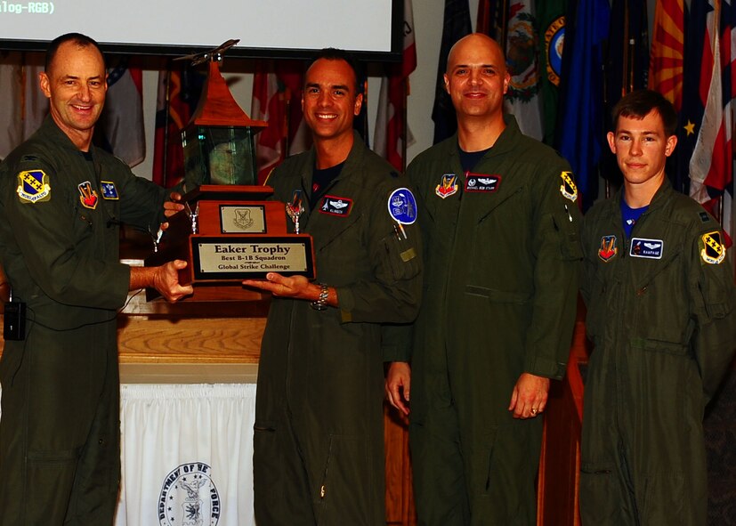 DYESS AIR FORCE BASE, Texas—Col. David Been, 7th Bomb Wing commander, presents the Eaker Trophy to Lt. Col. Patrick Klinger (left), Lt. Col. Michael Starr (middle), and Capt. Brad Weber (right), Nov. 19 here. Global Strike Challenge is the world’s premier bomber, intercontinental ballistic missile operations and security forces competition with units from Air Force Global Strike Command, Air Combat Command, Air Force Reserve Command and the Air National Guard. Team Dyess earned the Mithcell Trophy for Best Bomb, only 9 feet away from the target; Eaker Trophy for Best B-1 Operations; Best Bomb Munitions Maintenance Team Trophy; Ellis Giant Sword Trophy for Best Bomb Wing Maintenance; and the LeMay Trophy for Best Bomb Squadron, the 7th Operations Support Squadron. (U.S. Air Force photo/Airman 1st Class Brittney Frees)