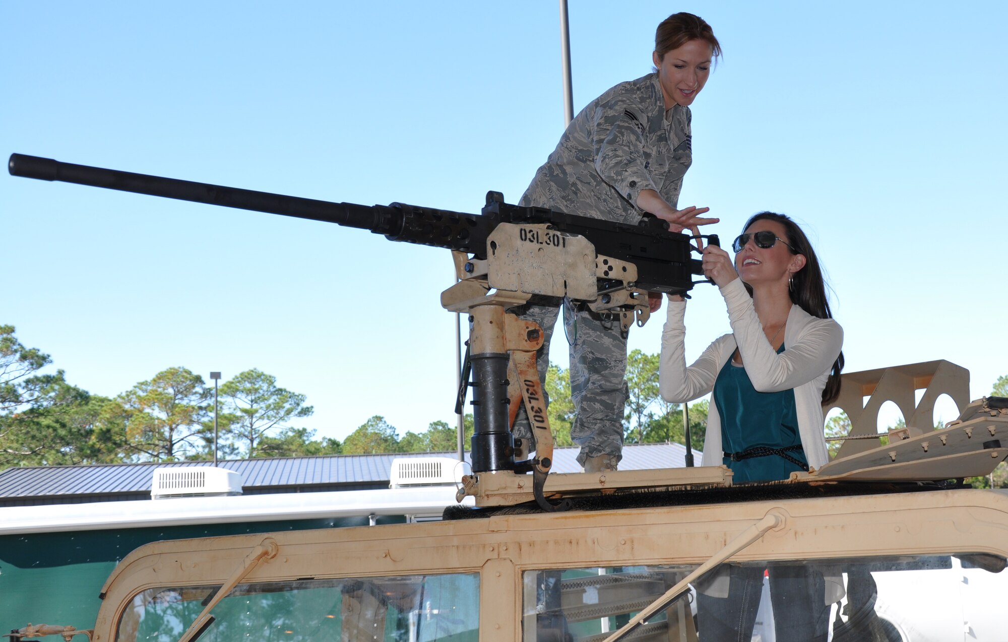 Staff Sgt. Annarose Schaad, Special Tactics Training Squadron weapons instructor, explains the functions of an M-2 machine gun to Becky Minger, Miss Ohio 2010, at the STTS at Hurlburt Field, Fla., Nov. 17, 2010. Ms. Minger, who will compete for the Miss America crown in January 2011, visited with Hurlburt Airmen before singing the national anthem at the Special Operations Warrior Foundation's Sixth Annual Emerald Coast Salute to Special Operations Forces Dinner later that evening. (U.S. Air Force Photo by Airman 1st Class Joe W. McFadden/Released)