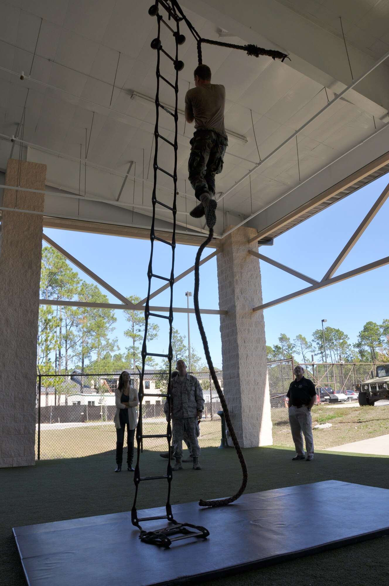 Becky Minger, Miss Ohio 2010, and Chief Master Sgt. Mickey Wright, Special Tactics Training Squadron chief enlisted manager, watch as a Special Tactics Airman climbs up a rope at the STTS at Hurlburt Field, Fla., Nov. 17, 2010. Ms. Minger, who will compete for the Miss America crown in January 2011, visited with Hurlburt Airmen before singing the national anthem at the Special Operations Warrior Foundation's Sixth Annual Emerald Coast Salute to Special Operations Forces Dinner later that evening. (U.S. Air Force Photo by Airman 1st Class Joe W. McFadden/Released)
