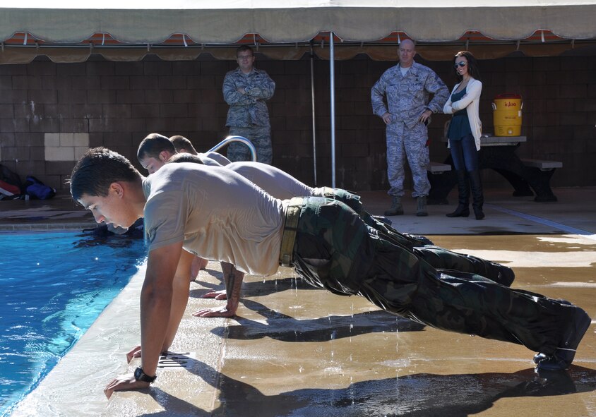 Becky Minger, Miss Ohio 2010, and Chief Master Sgt. Mickey Wright, Special Tactics Training Squadron chief enlisted manager, watch special tactics Airmen conduct pushups during pool training at the STTS at Hurlburt Field, Fla., Nov. 17, 2010. Ms. Minger, who will compete for the Miss America crown in January 2011, visited with Hurlburt Airmen before singing the national anthem at the Special Operations Warrior Foundation's Sixth Annual Emerald Coast Salute to Special Operations Forces Dinner later that evening. (U.S. Air Force Photo by Airman 1st Class Joe W. McFadden/Released)