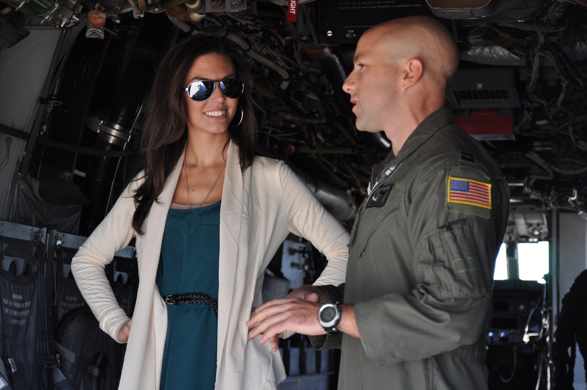 Becky Minger, Miss Ohio 2010, listens as Capt. Robert Marshall, 8th Special Operations Squadron CV-22 pilot, explains the capabilities of the aircraft outside his squadron at Hurlburt Field, Fla., Nov. 17, 2010. Ms. Minger, who will compete for the Miss America crown in January 2011, visited with Hurlburt Airmen before singing the national anthem at the Special Operations Warrior Foundation's Sixth Annual Emerald Coast Salute to Special Operations Forces Dinner later that evening. (U.S. Air Force Photo by Airman 1st Class Joe W. McFadden/Released)