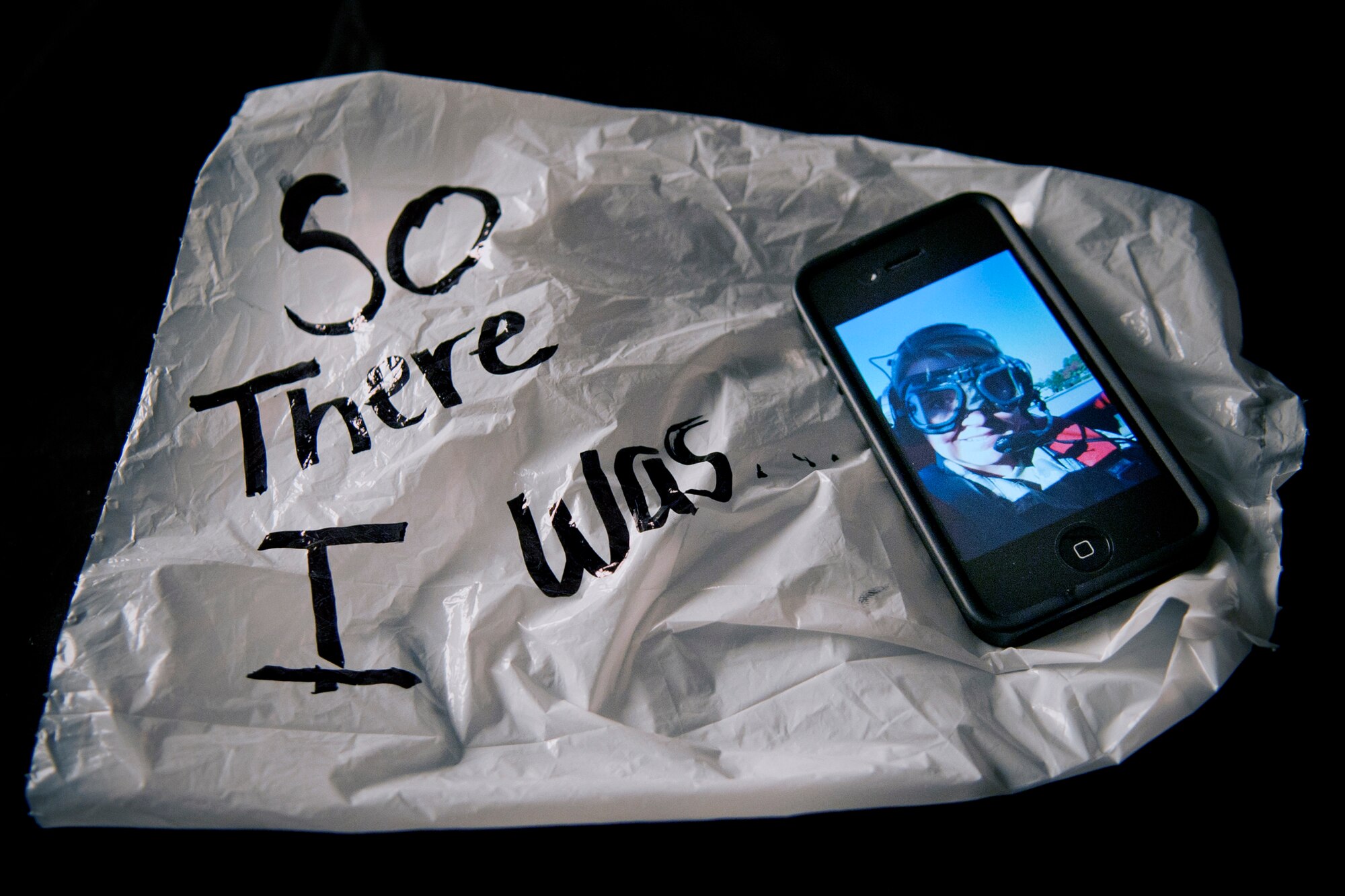 A self portrait taken on a cell phone and an airsick bag -- a few momentos from Staff Sgt. Andrea Thacker's first ride in an open cockpit aircraft Nov. 11, 2010, over Valdosta, Ga. (U.S. Force photo illustration/Staff Sgt. Andrea Thacker)