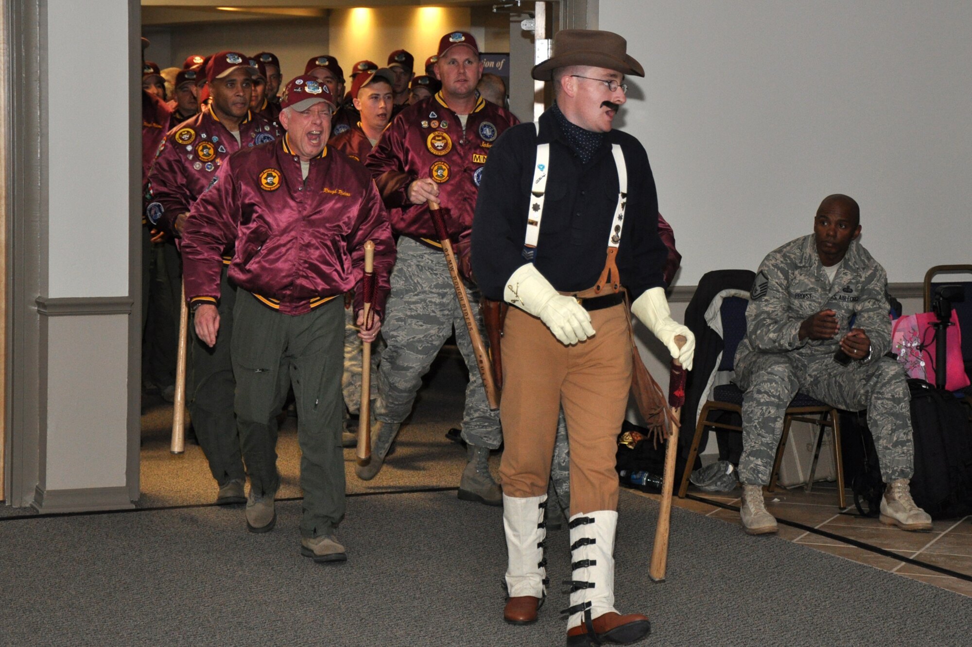 Teddy Roosevelt (actor) leads his “Rough Riders” from the 91st Missile Wing at Minot Air Force Base, N.D., into Hoban Hall at Barksdale Air Force Base, La., for the first night of score postings during the first-ever Global Strike Challenge, Nov. 16, 2010. Several of the teams at the score posting had mascots for their units, which is a time-honored tradition for these types of competitions. More than 400 Airmen from many bases joined in the competition that began in April. The competition wraps up November 17, with the awarding of trophies to the final winners. (U.S. Air Force photo/Tech. Sgt. Jeff Walston)