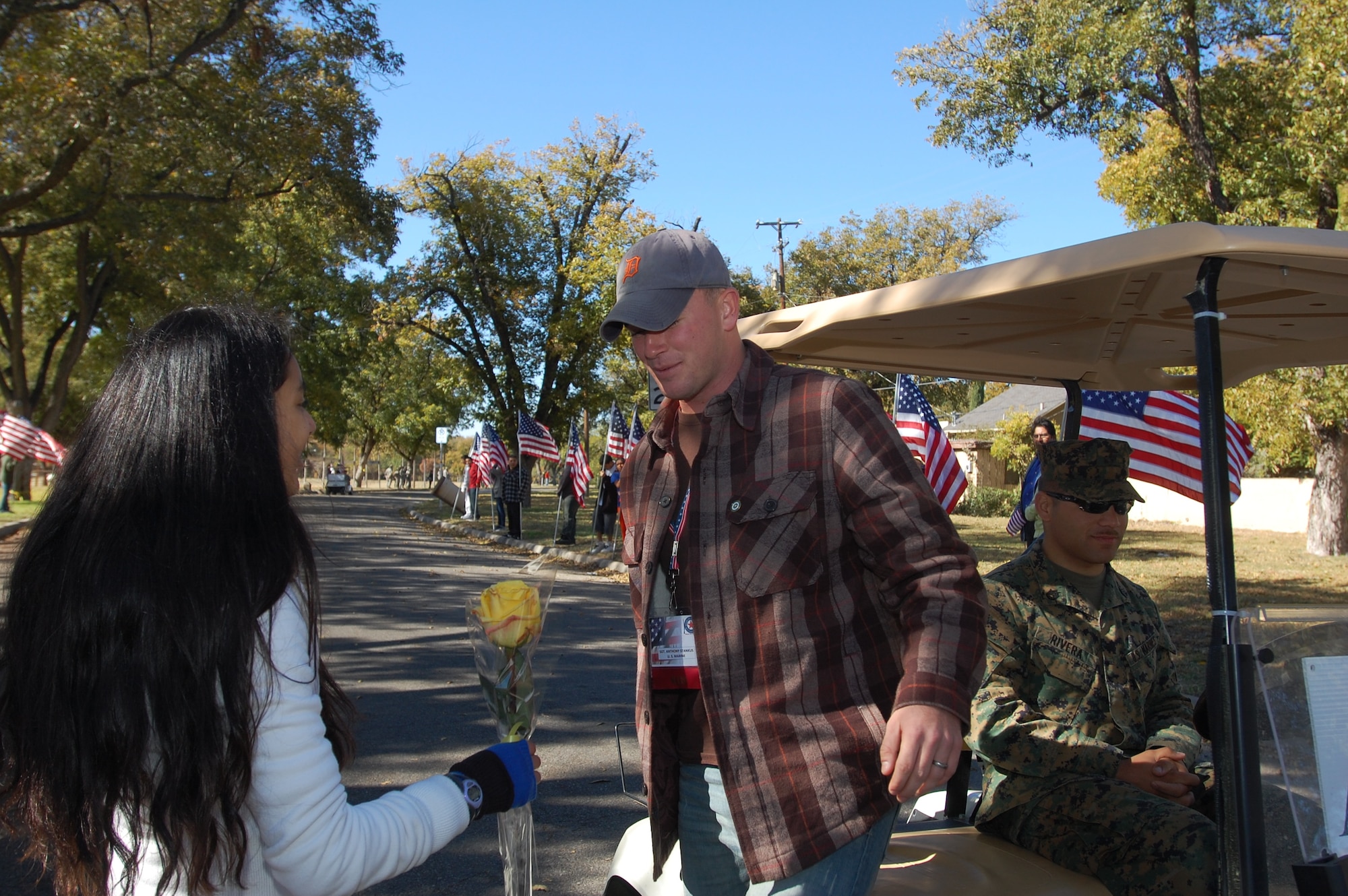 101119-F-9995R-162
SAN ANGELO, Texas –Marine Sgt. Anthony Stankus stands to receive a rose from Jabyn Cleere, 13, a student at Glen Middle School, during the Hunt for Heroes Parade Nov. 19.  Sergeant Stankus is one of 25 wounded warriors from all services that participated in the parade and received tokens of appreciation from local citizens. (U.S. Air Force photo/Staff Sgt. Heather Rodgers)
