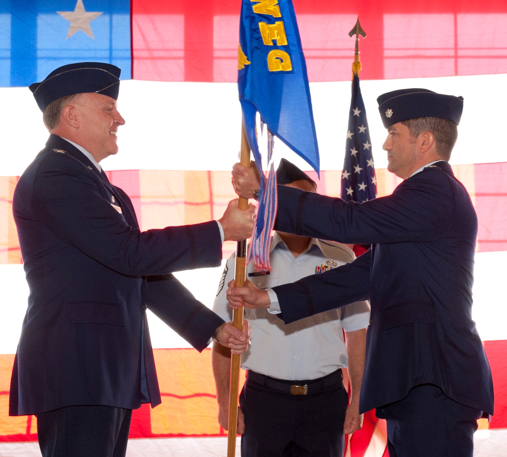 Col. Bert Dreher, 53rd Weapons Evaluation Group commander, passes the 53 rd Test Support Squadron guidon to Lt. Col. James Sukenik, the new commander of the squadron. (U.S. Air Force photo by Jonathan Gibson) 