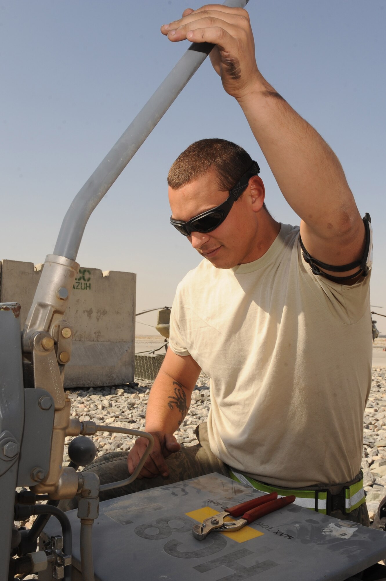 Senior Airman Joshua Hensell builds hydraulic fluid pressure to service the main landing struts on an HH-60G Pave Hawk helicopter Nov. 17, 2010, at Kandahar Airfield, Afghanistan. Airman Hensell, from Columbus, Ohio, is a crew chief assigned to the 451st Expeditionary Aircraft Maintenance Squadron, 55th Expeditionary Helicopter Maintenance Unit. (U.S. Air Force photo by Tech. Sgt. Chad Chisholm/Released)